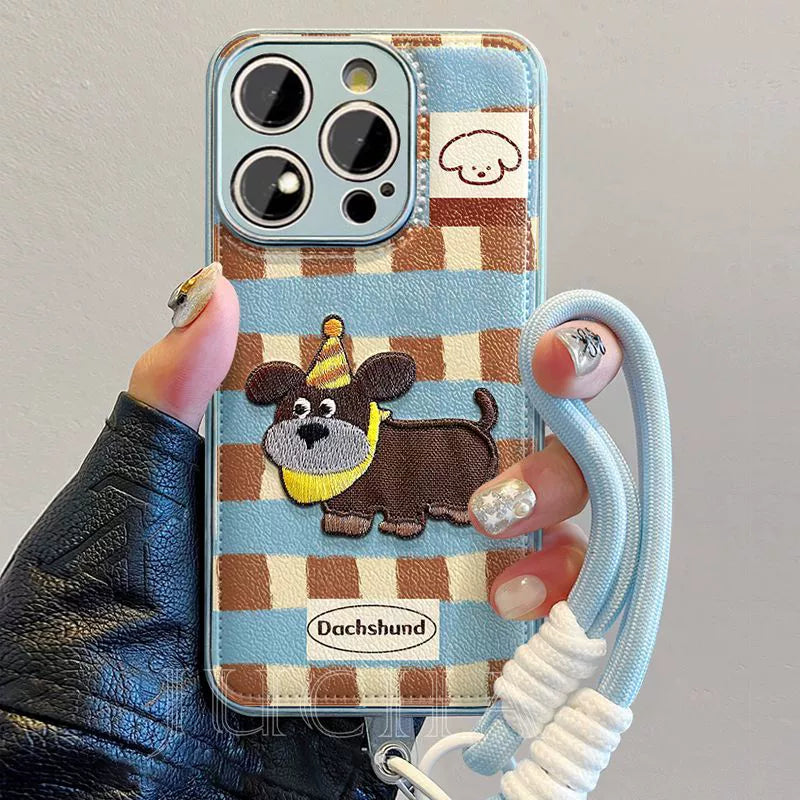 A luxurious smartphone case with a string, featuring a gingham embroidered puppy motif, compatible with iPhone