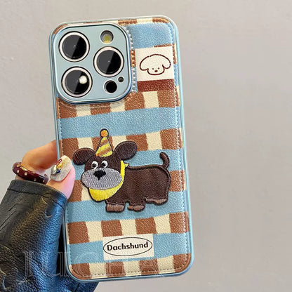 A luxurious smartphone case with a string, featuring a gingham embroidered puppy motif, compatible with iPhone